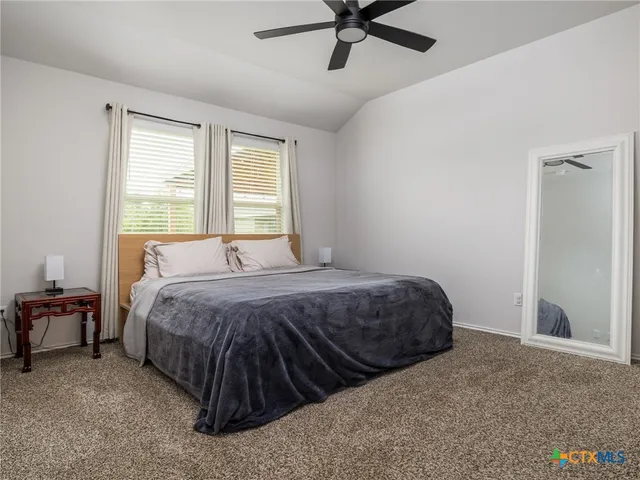 a bedroom with a bed and window