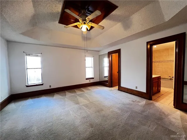 a view of an empty room with a ceiling fan