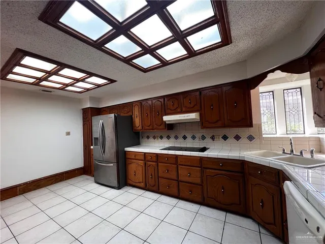 a kitchen with a sink and wooden cabinets