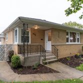 front view of a house with a bench