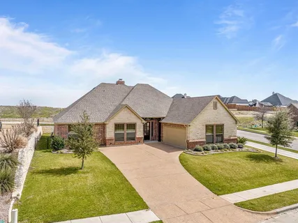 a view of house with yard in front of it