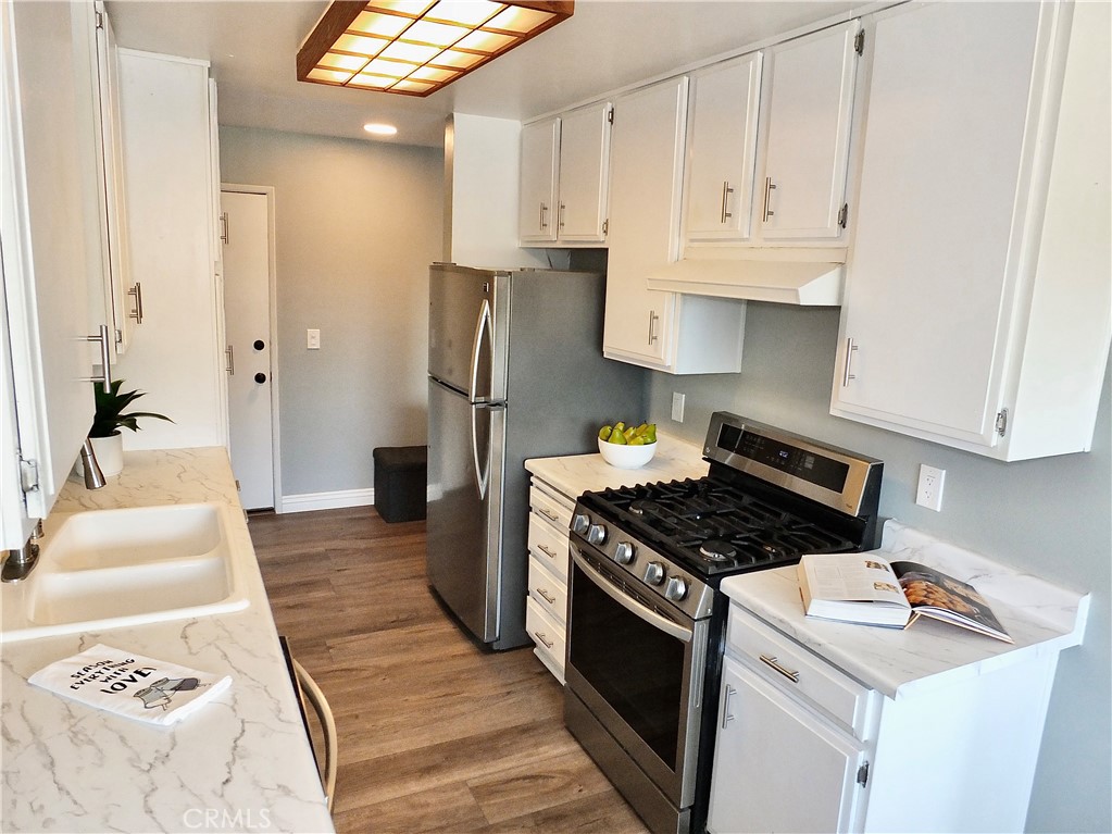 4591 Orange Avenue, Unit 306 Long Beach, CA 90807 - Photo 11 of 34 a kitchen with granite countertop a sink stove and refrigerator