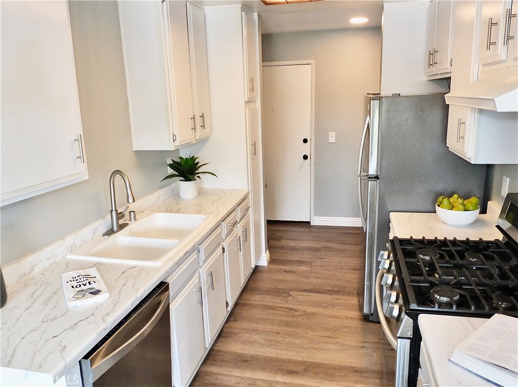 4591 Orange Avenue, Unit 306 Long Beach, CA 90807 - Photo 12 of 34 a en suite bathroom with a sink and a mirror