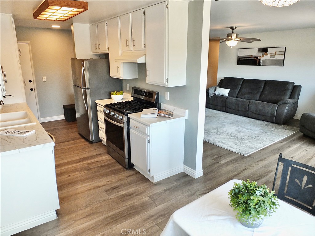 4591 Orange Avenue, Unit 306 Long Beach, CA 90807 - Photo 15 of 34 a kitchen with a stove and a white refrigerator