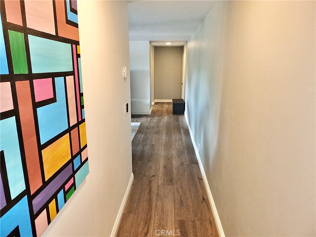 4591 Orange Avenue, Unit 306 Long Beach, CA 90807 - Photo 16 of 34 a view of a hallway with wooden floor and stairs