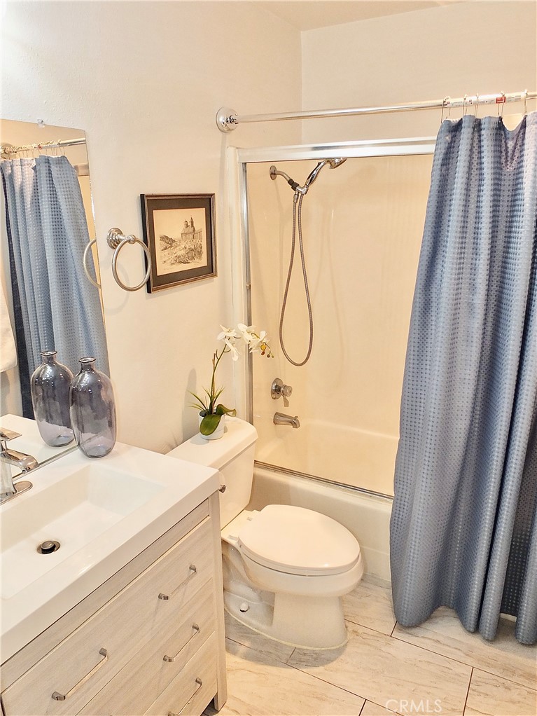 4591 Orange Avenue, Unit 306 Long Beach, CA 90807 - Photo 18 of 34 a bathroom with a granite countertop sink toilet and shower