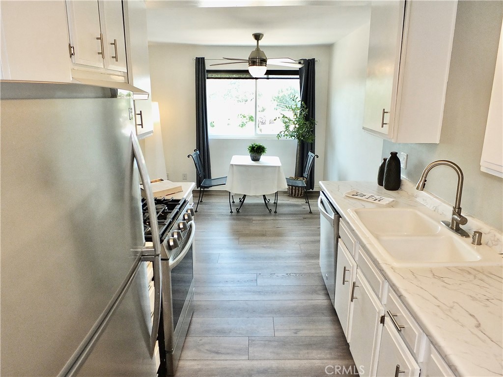 4591 Orange Avenue, Unit 306 Long Beach, CA 90807 - Photo 2 of 34 a bathroom with sink a mirror and a shower