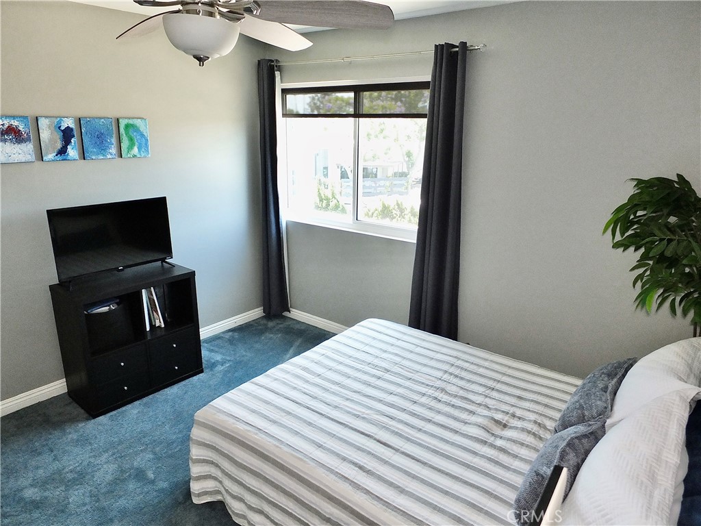 4591 Orange Avenue, Unit 306 Long Beach, CA 90807 - Photo 26 of 34 a bedroom with a bed and a television
