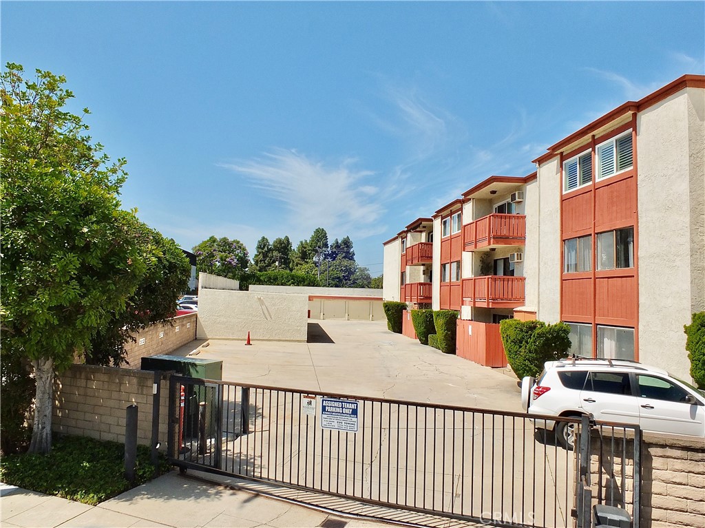 4591 Orange Avenue, Unit 306 Long Beach, CA 90807 - Photo 34 of 34 a view of a brick building from a balcony