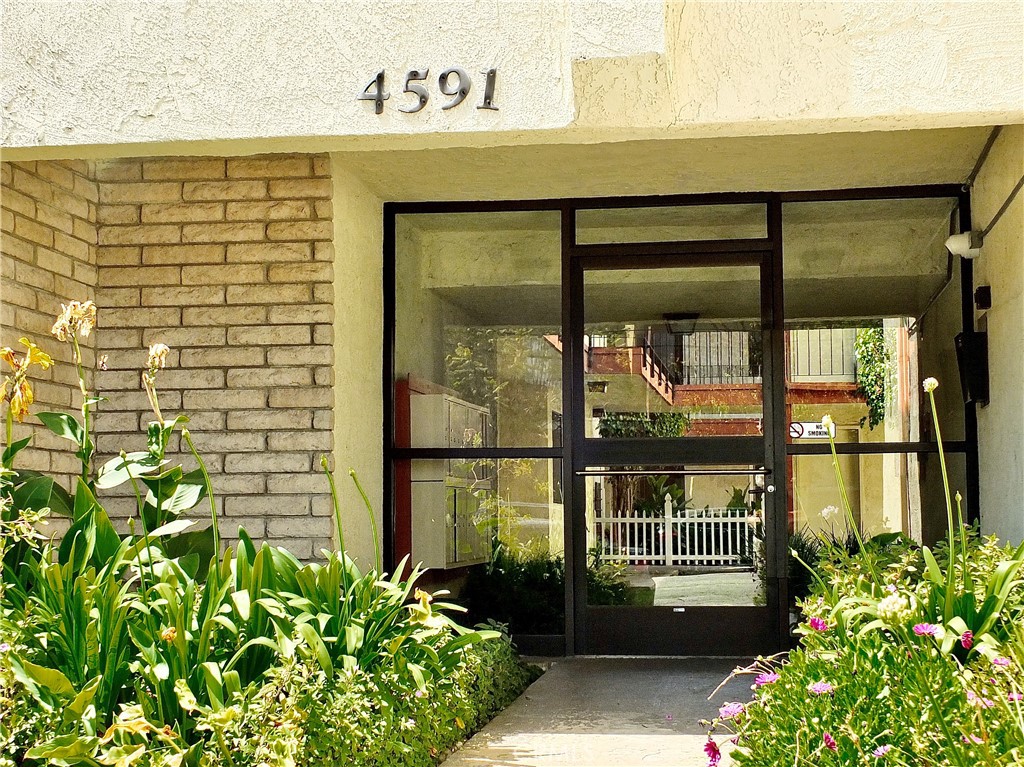 4591 Orange Avenue, Unit 306 Long Beach, CA 90807 - Photo 7 of 34 a front view of a house with a flower garden