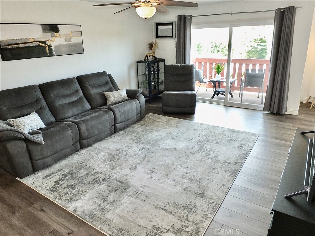 4591 Orange Avenue, Unit 306 Long Beach, CA 90807 - Photo 9 of 34 a living room with furniture and a flat screen tv