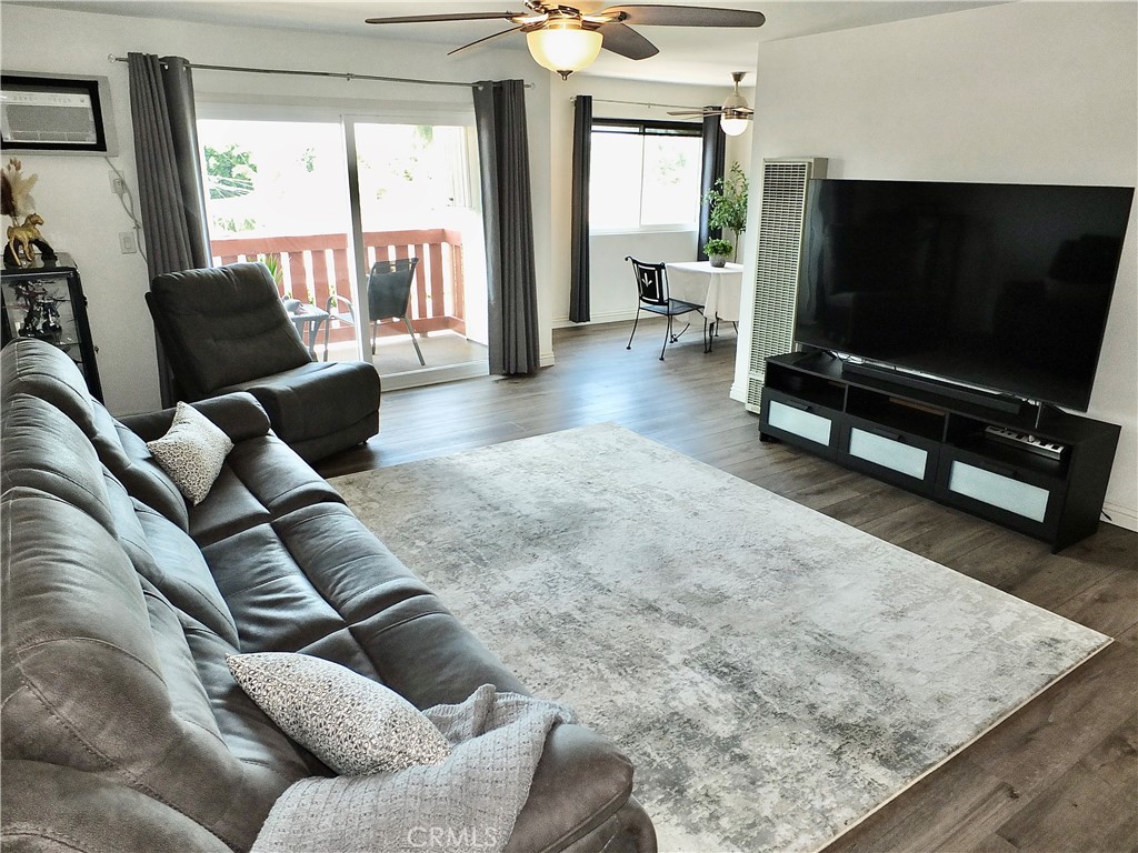 4591 Orange Avenue, Unit 306 Long Beach, CA 90807 - Photo 10 of 34 a living room with furniture and a flat screen tv