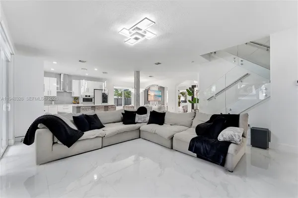 a living room with furniture and a chandelier