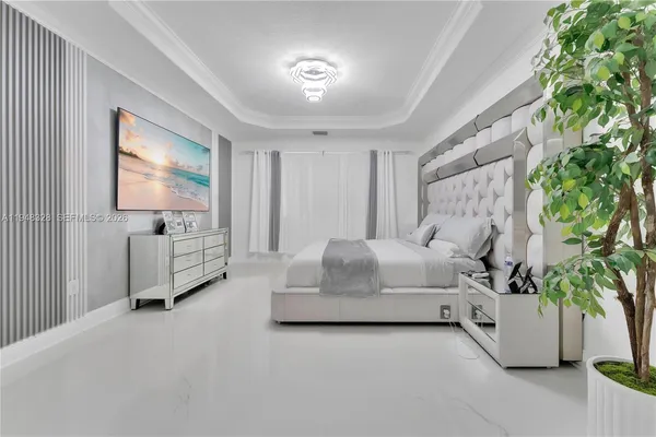 a spacious bedroom with a bed and a potted plant