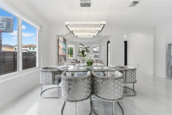 a dining room with furniture and window