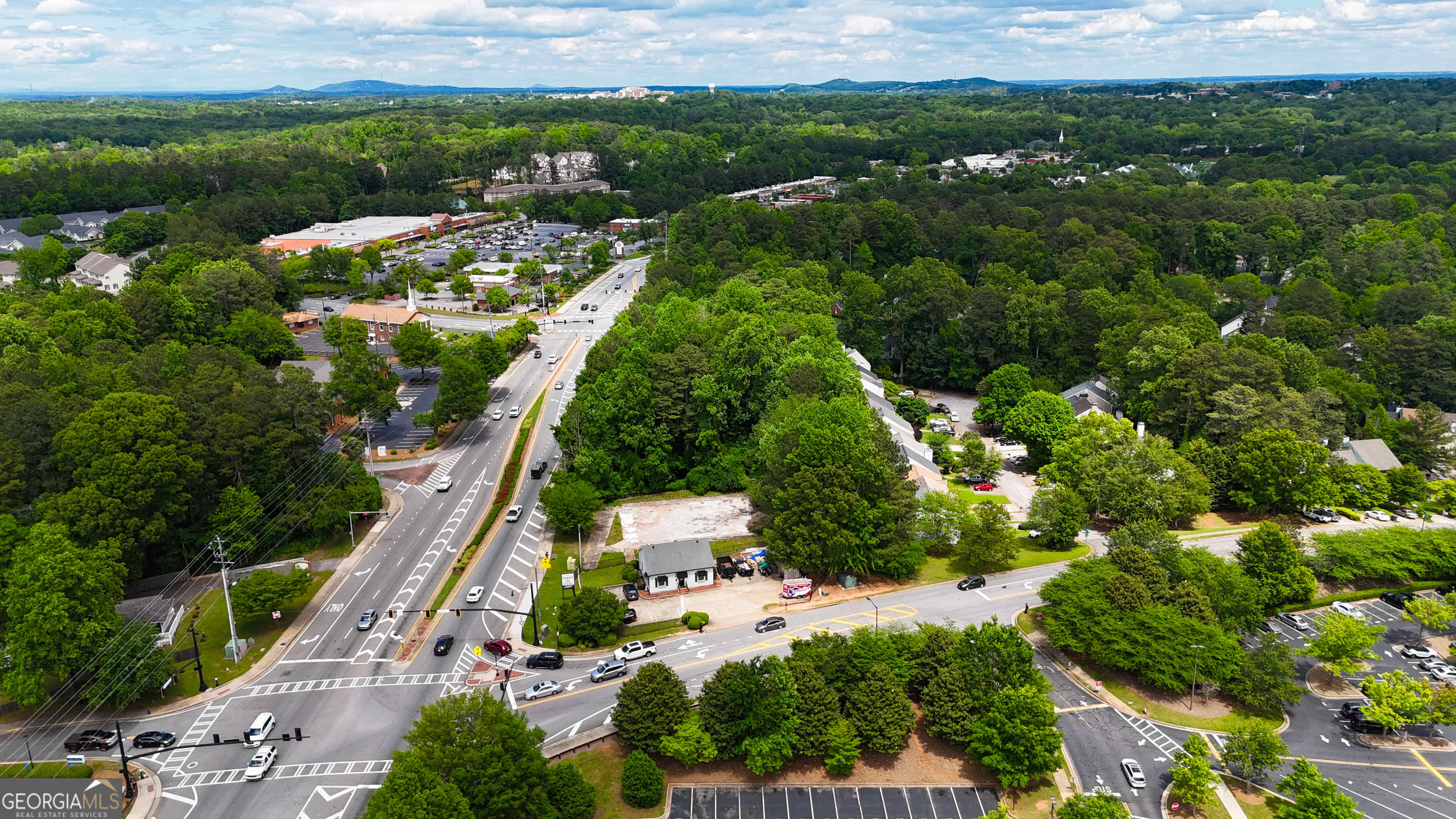 1141 Whitlock Avenue Southwest Marietta, GA 30064 - Photo 6 of 22 an aerial view of residential houses with outdoor space and trees