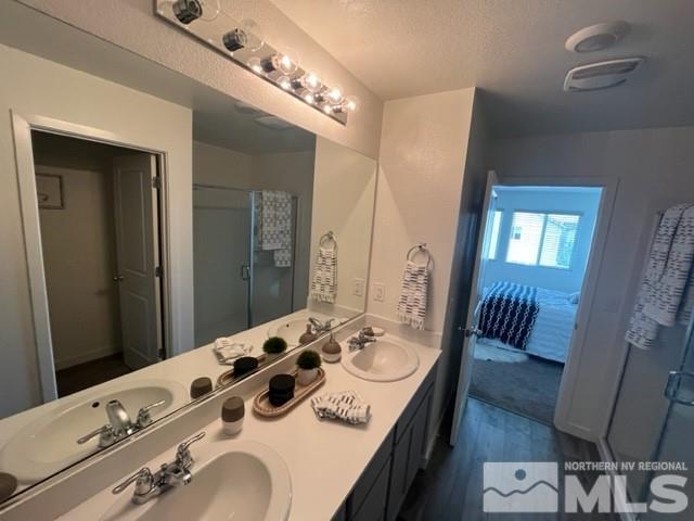 8831 Gazing Star Drive Reno, NV 89506 - Photo 17 of 27 a bathroom with a sink double vanity granite and a mirror