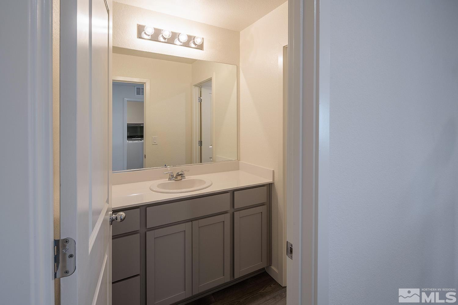 8831 Gazing Star Drive Reno, NV 89506 - Photo 19 of 27 a bathroom with a double vanity sink and mirror