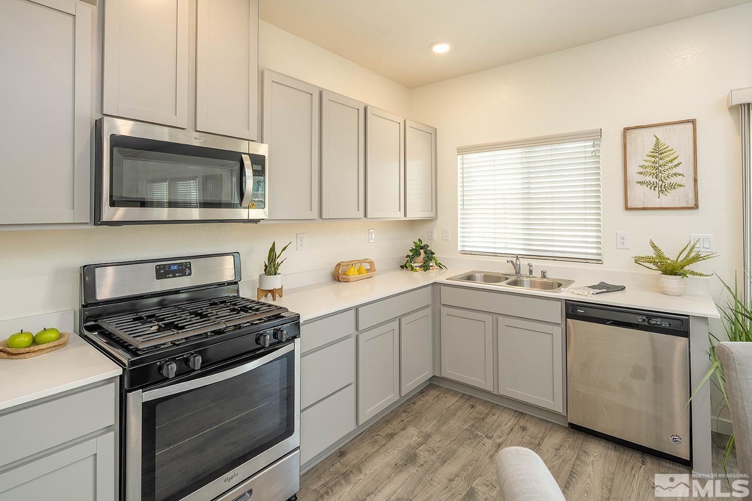 8831 Gazing Star Drive Reno, NV 89506 - Photo 4 of 27 a kitchen with granite countertop cabinets stainless steel appliances and a sink