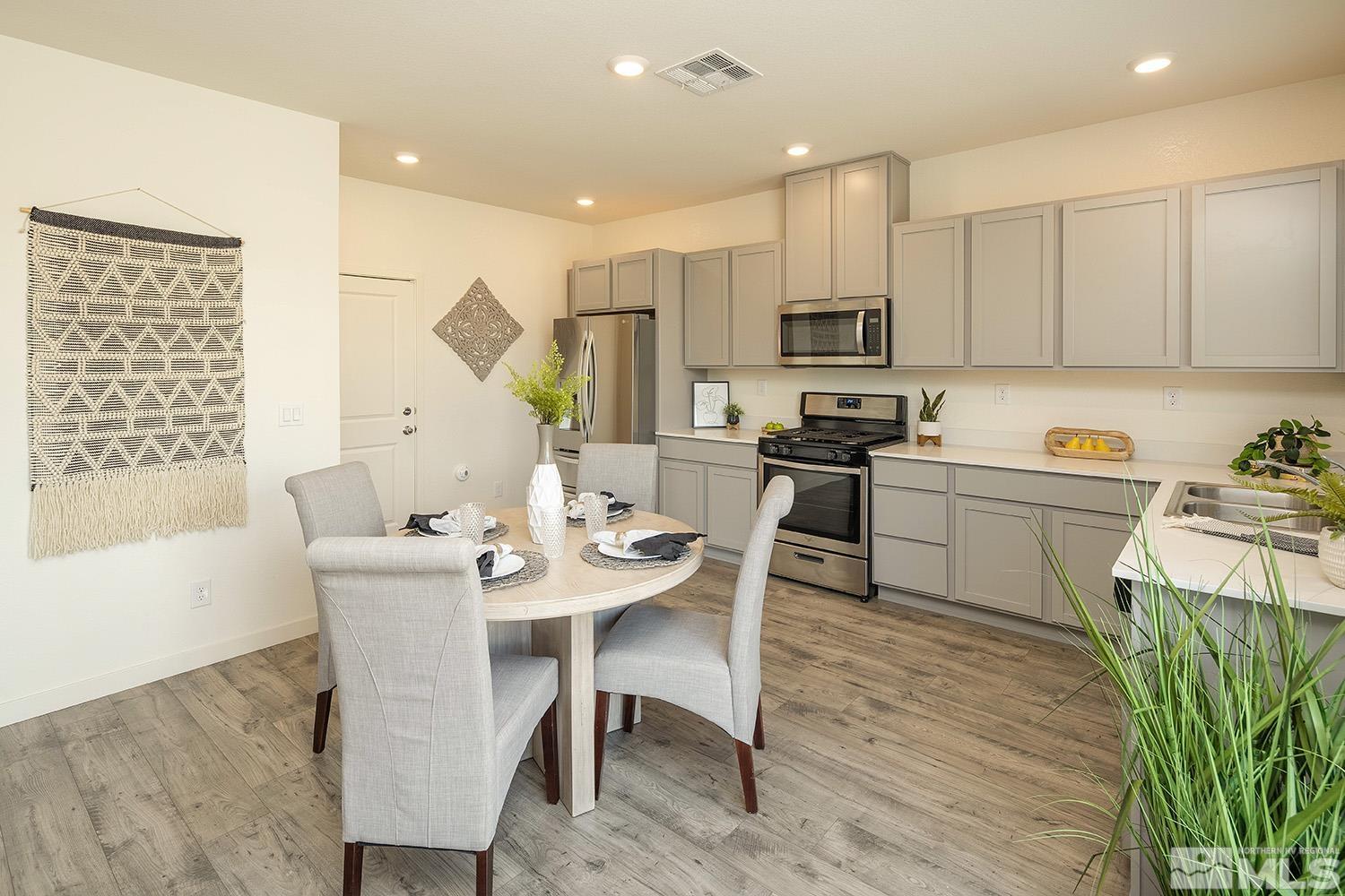 8831 Gazing Star Drive Reno, NV 89506 - Photo 5 of 27 a kitchen with a table chairs microwave and cabinets
