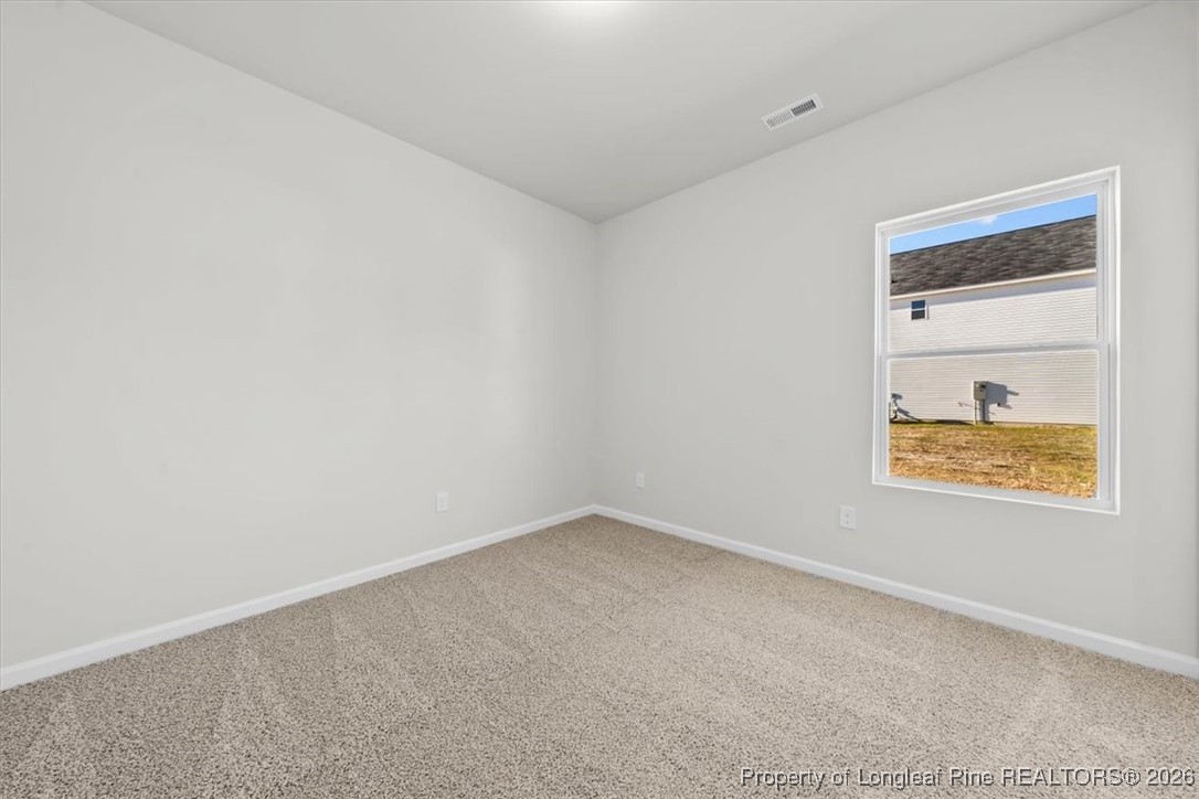 266 Happy Trail Road Aberdeen, NC 28315 - Photo 21 of 34 an empty room with a window