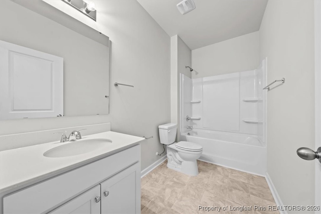 266 Happy Trail Road Aberdeen, NC 28315 - Photo 25 of 34 a bathroom with a sink toilet a shower and a mirror