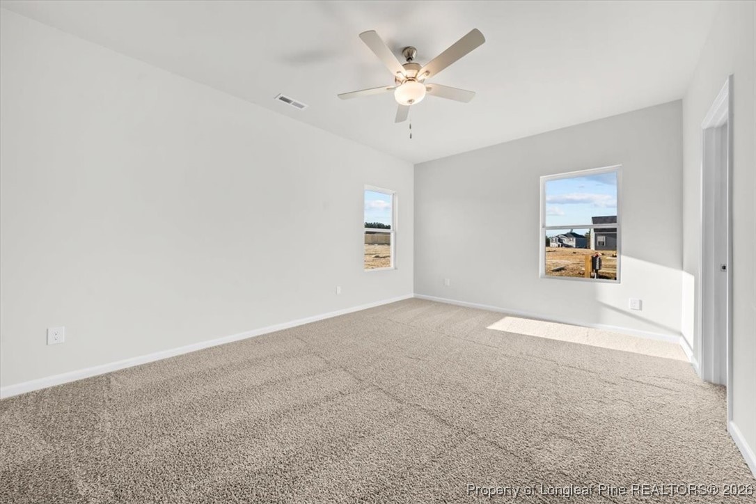 266 Happy Trail Road Aberdeen, NC 28315 - Photo 26 of 34 an empty room with a empty space and a ceiling fan