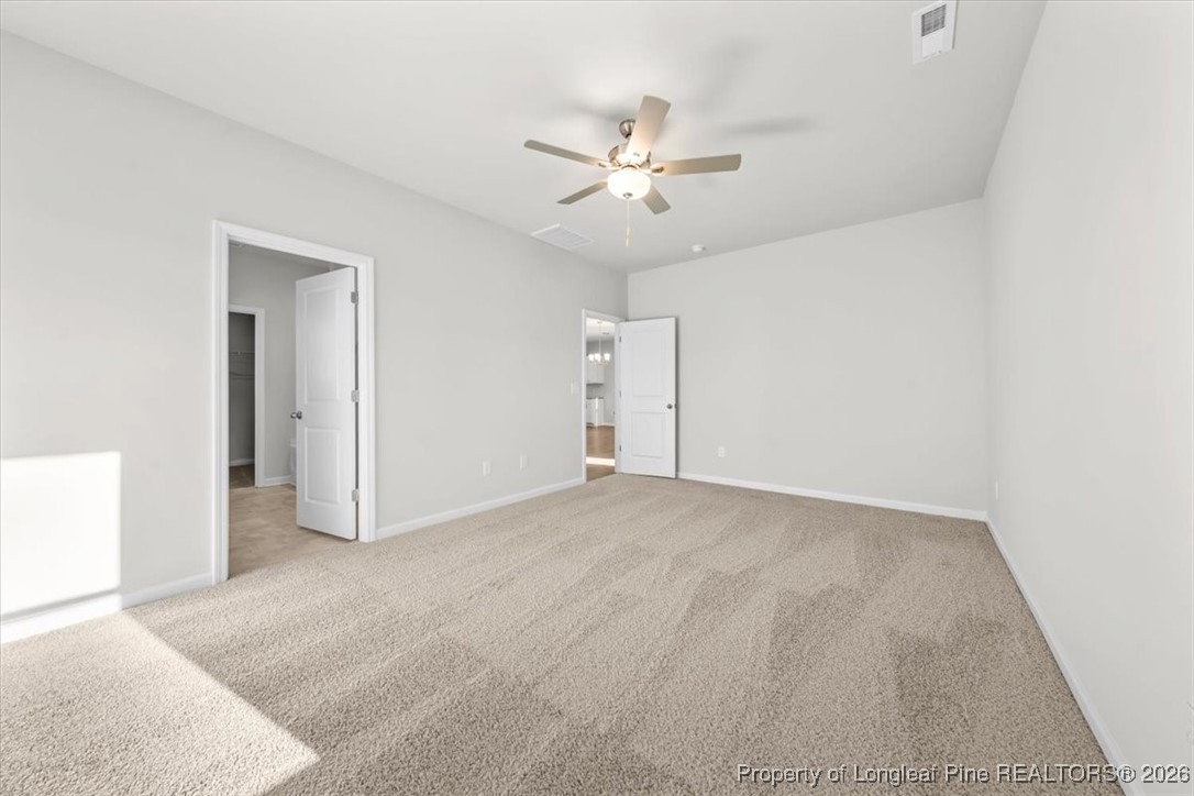 266 Happy Trail Road Aberdeen, NC 28315 - Photo 28 of 34 a view of an empty room with a ceiling fan