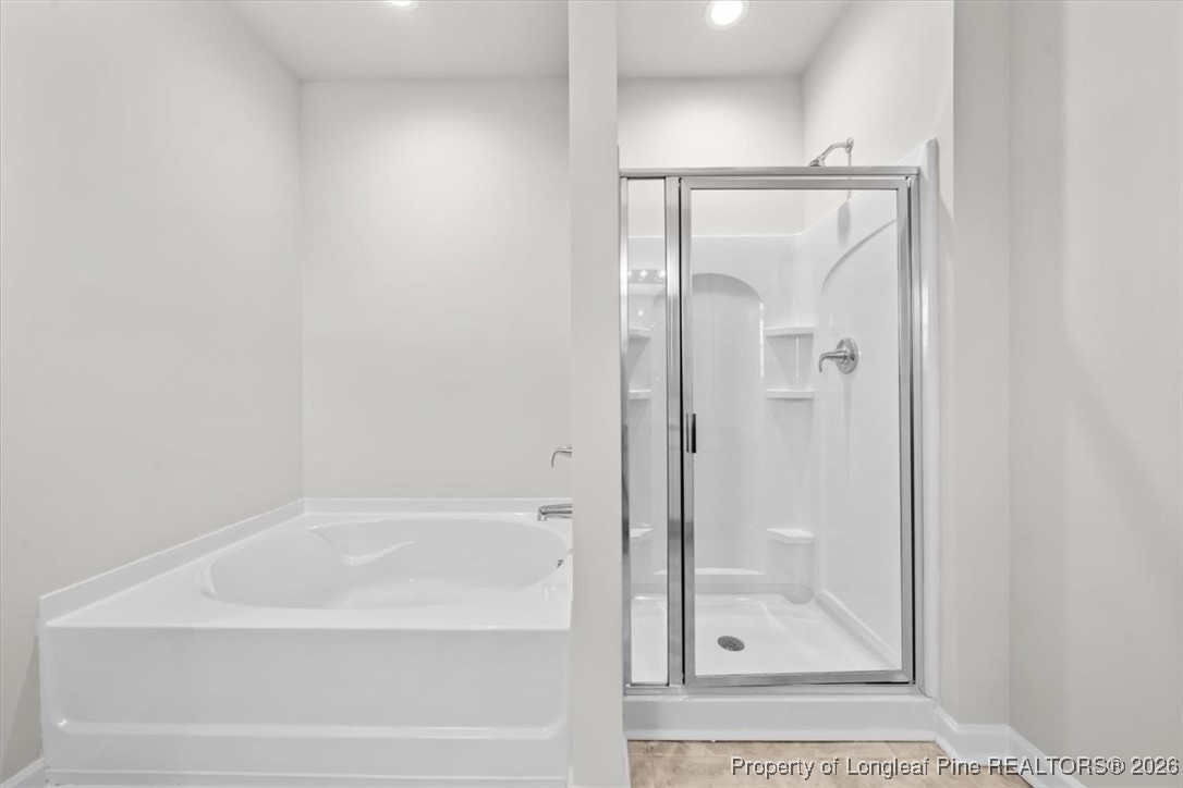 266 Happy Trail Road Aberdeen, NC 28315 - Photo 31 of 34 a bathroom with a glass shower door