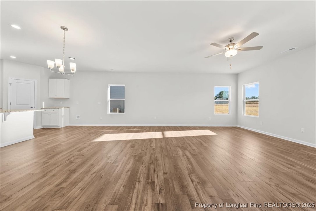 266 Happy Trail Road Aberdeen, NC 28315 - Photo 10 of 34 a view of an empty room with window and wooden floor