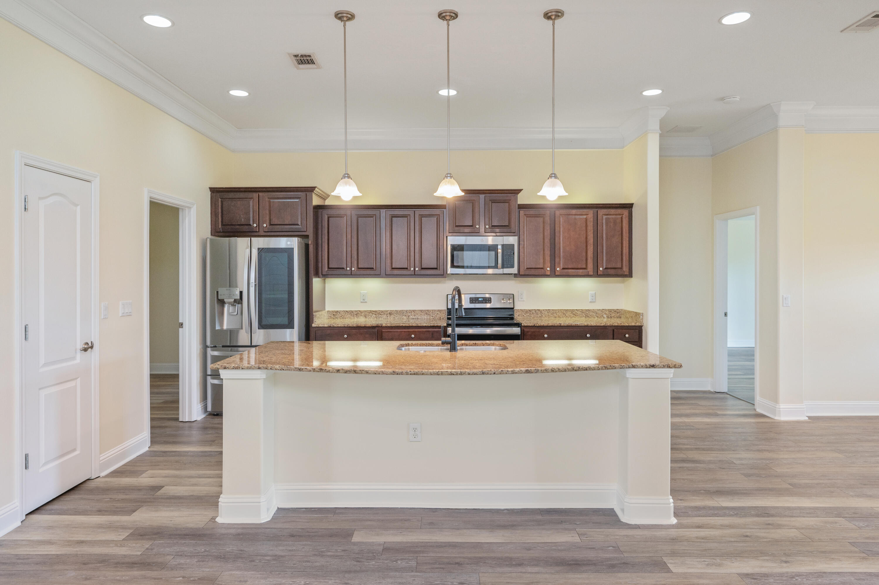 3361 Citrine Circle Crestview, FL 32539 - Photo 8 of 34 a kitchen with kitchen island a island a stove a refrigerator and a island