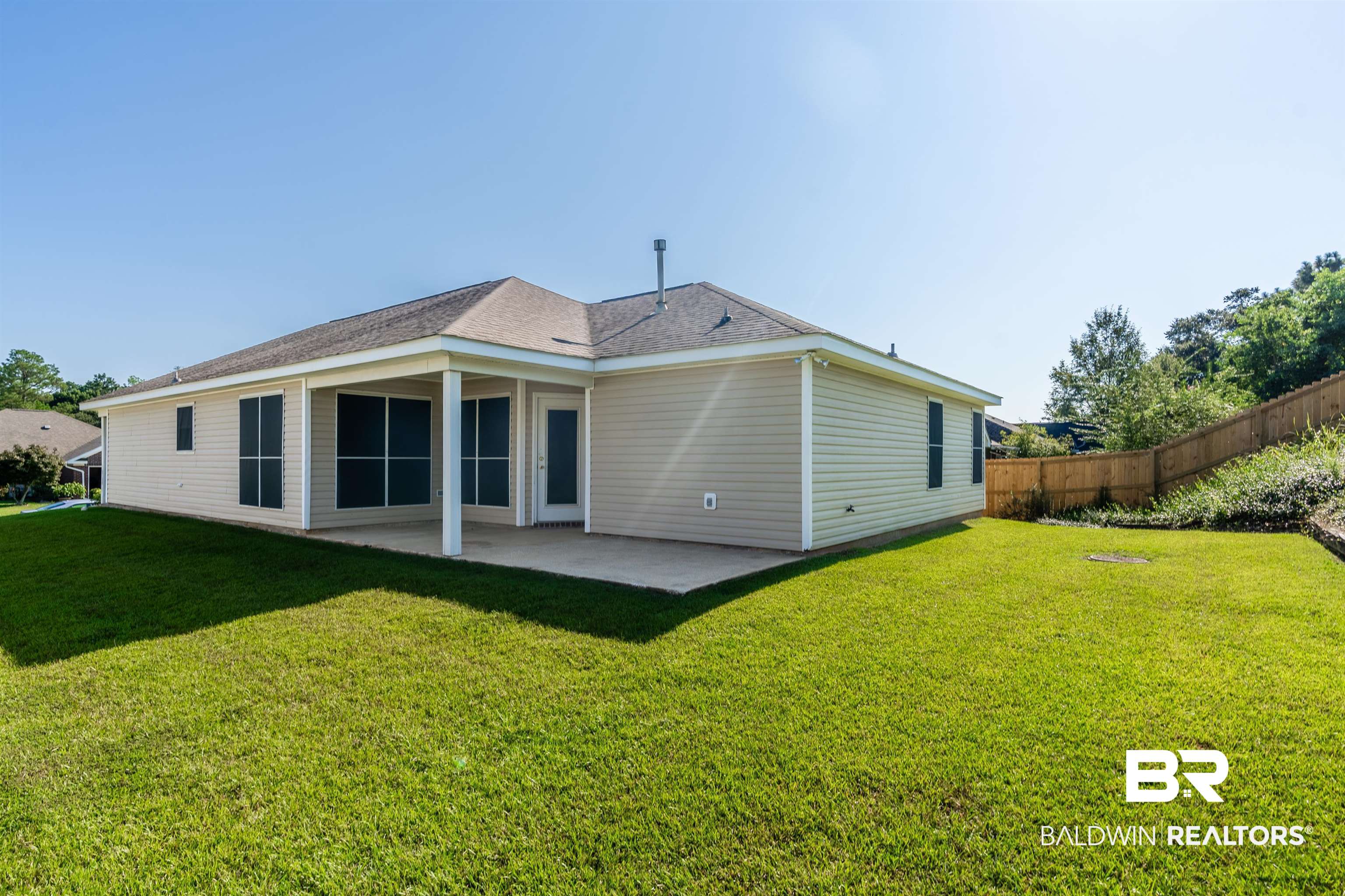 1784 Harrington Way Mobile, AL 36695 - Photo 17 of 18 Back of house featuring a patio and a lawn