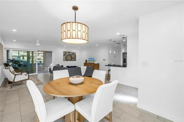 a kitchen with stainless steel appliances kitchen island granite countertop a refrigerator and a sink
