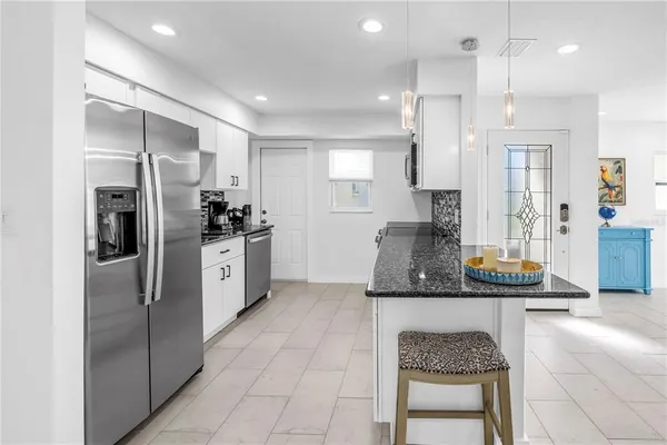 a kitchen with stainless steel appliances a refrigerator and a sink
