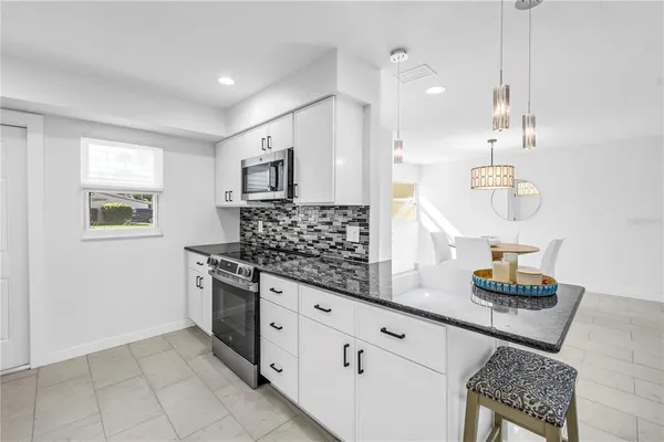 a living room with furniture and kitchen view