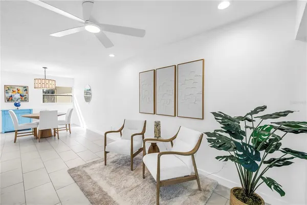 a living room with furniture and a potted plant