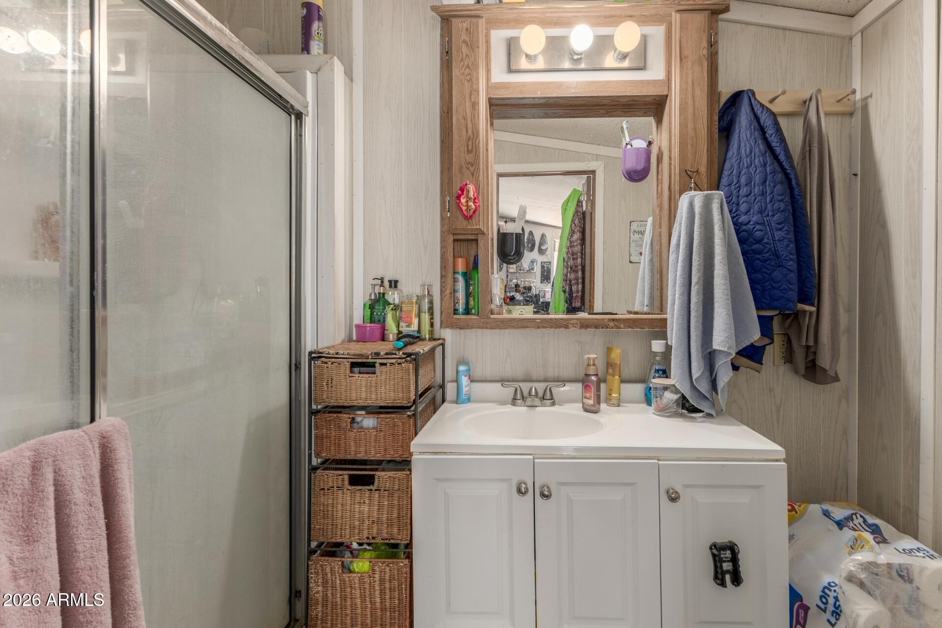 20917 West Black Butte Road Wittmann, AZ 85361 - Photo 13 of 22 a bathroom with a sink vanity and mirror