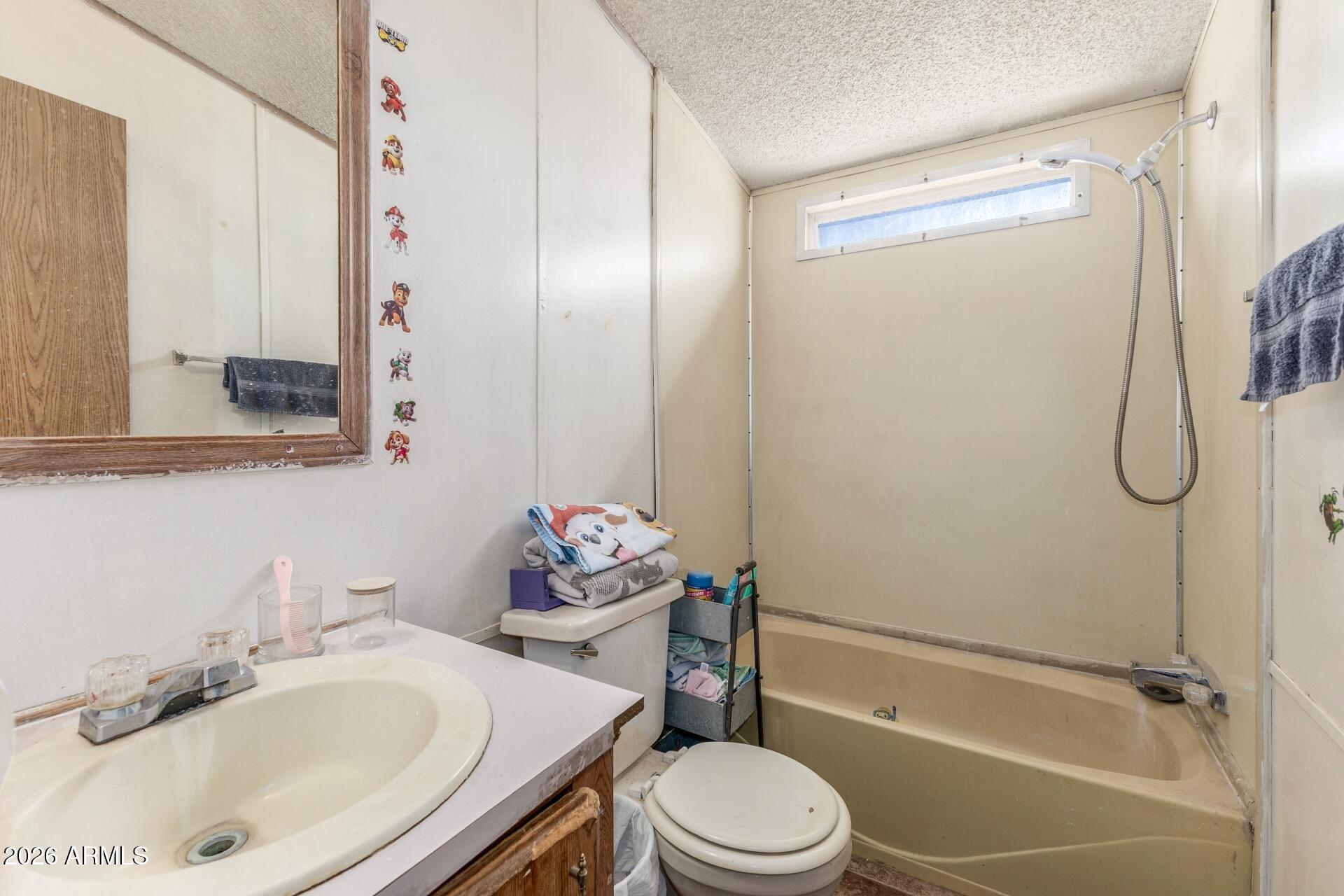 20917 West Black Butte Road Wittmann, AZ 85361 - Photo 14 of 22 a bathroom with a sink toilet and shower