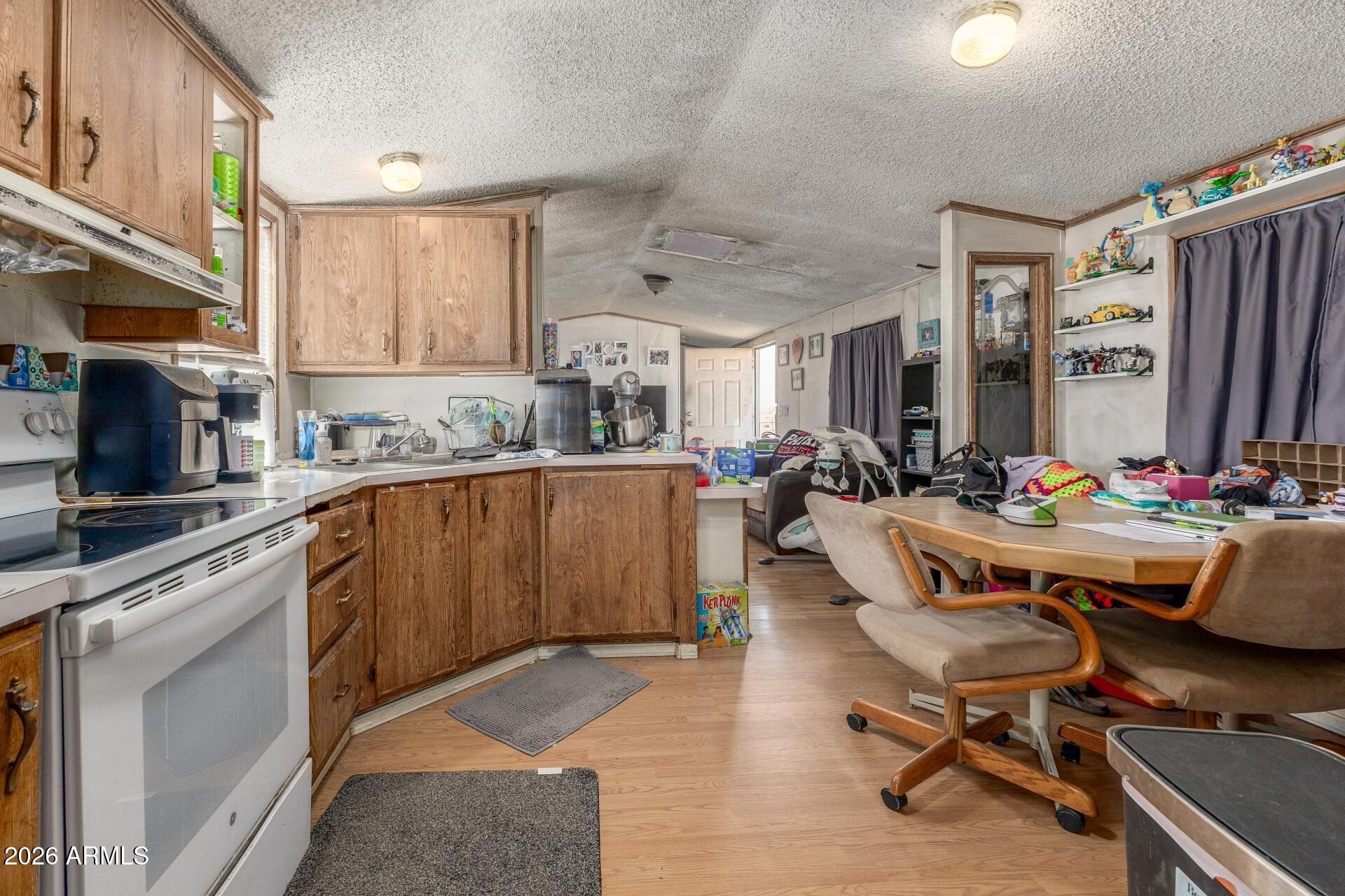 20917 West Black Butte Road Wittmann, AZ 85361 - Photo 8 of 22 a kitchen with a table chairs sink and cabinets