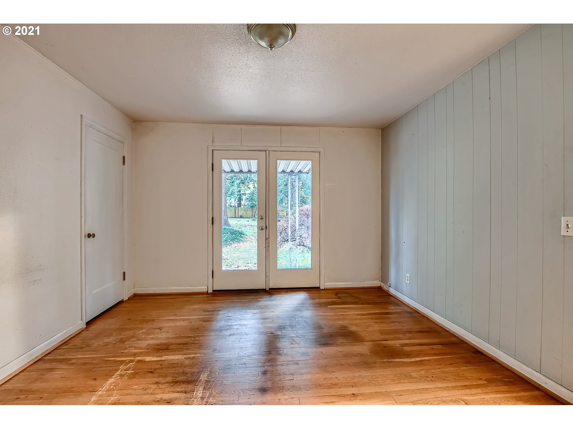 12044 Southeast Foster Road Portland, OR 97266 - Photo 14 of 28 a view of an empty room with wooden floor and a window