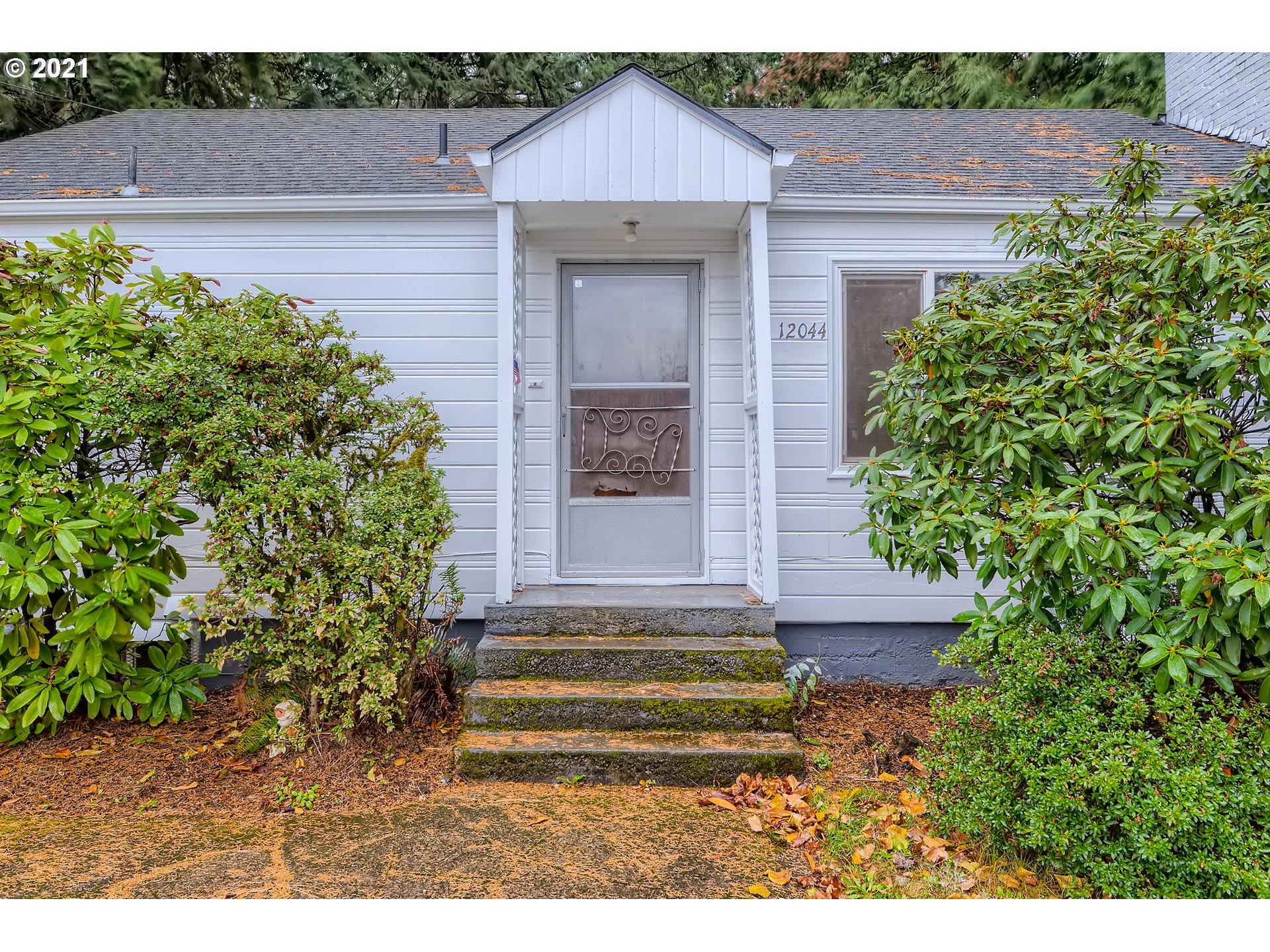 12044 Southeast Foster Road Portland, OR 97266 - Photo 3 of 28 a front view of a house with a garden