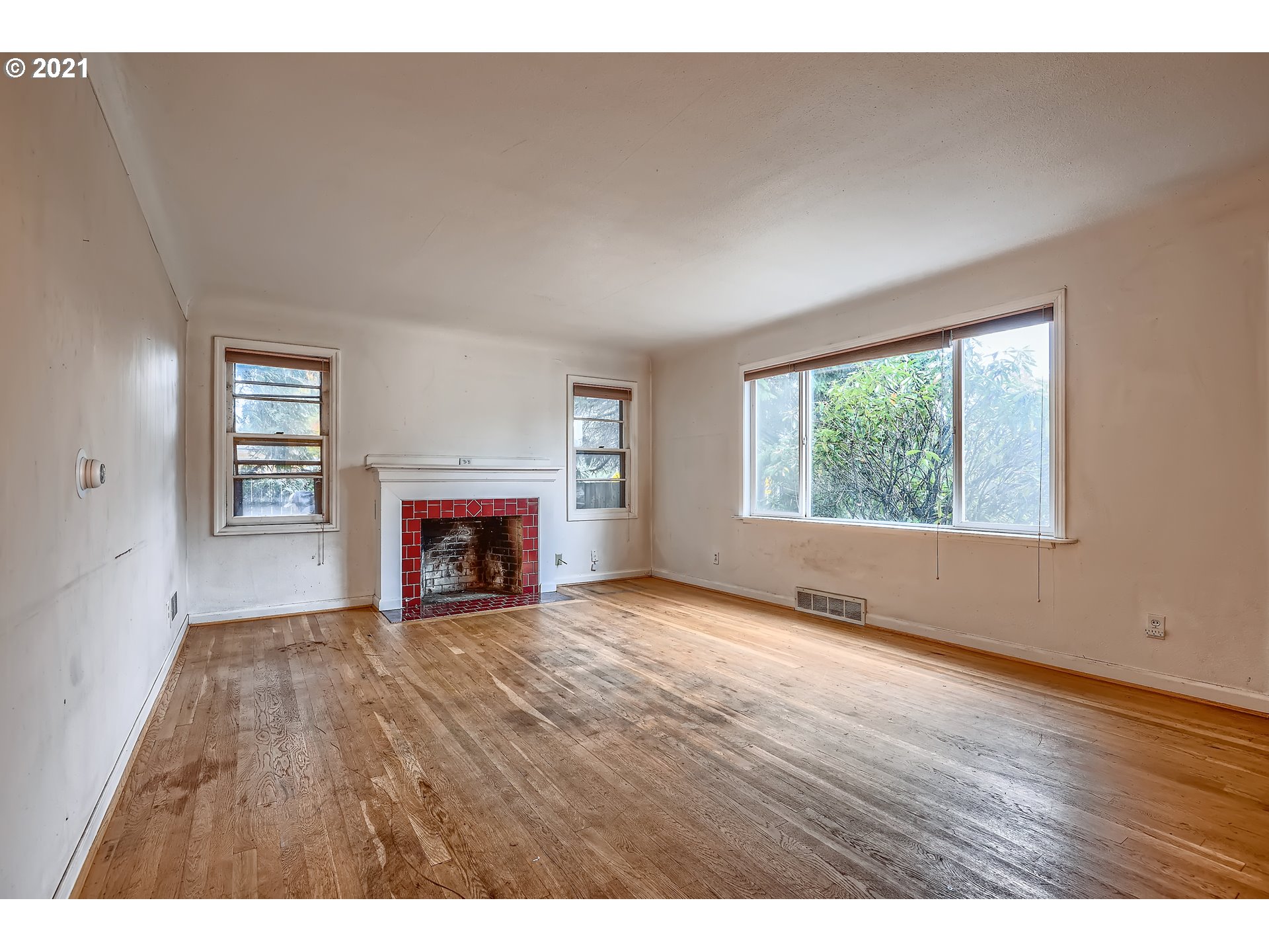 12044 Southeast Foster Road Portland, OR 97266 - Photo 5 of 28 a view of an empty room with a window and fireplace