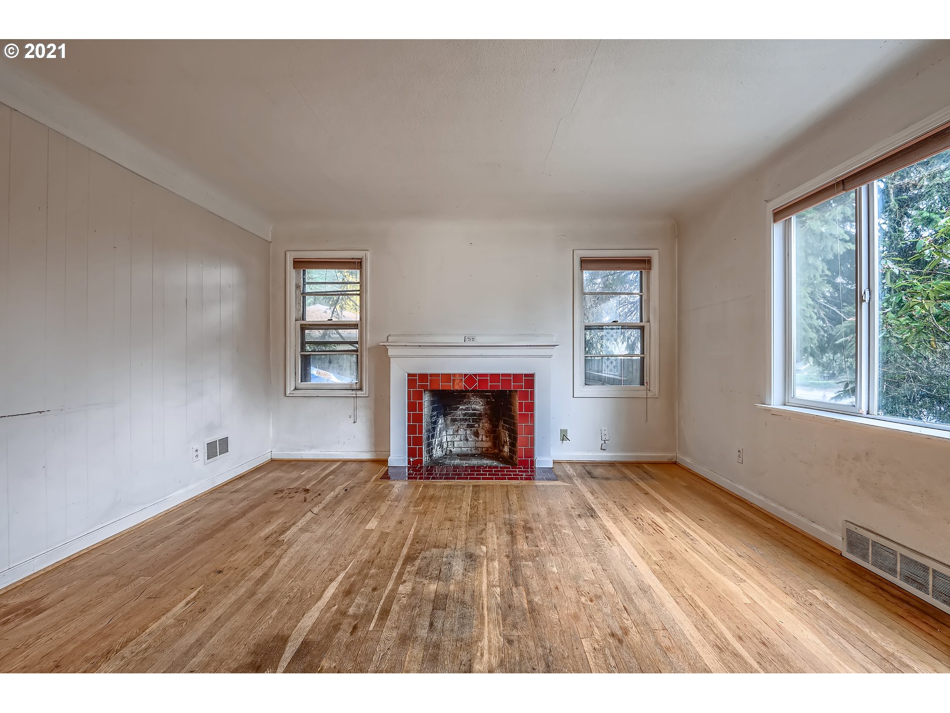 12044 Southeast Foster Road Portland, OR 97266 - Photo 6 of 28 a view of an empty room with a window and fireplace