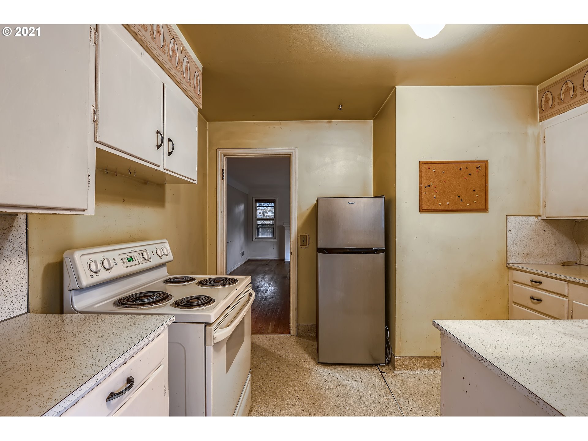 12044 Southeast Foster Road Portland, OR 97266 - Photo 9 of 28 a kitchen with a refrigerator a stove top oven a sink and dishwasher
