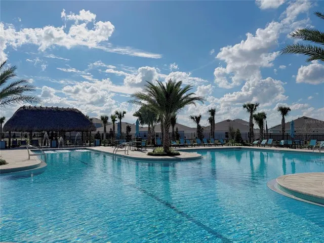 a view of a swimming pool with lounge chair