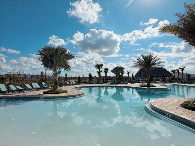 a view of swimming pool with outdoor seating