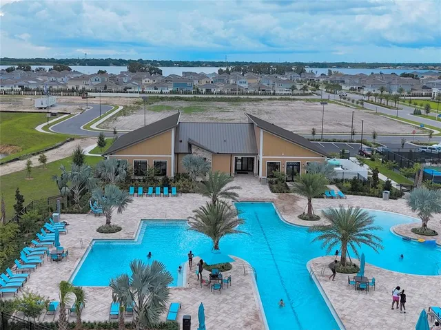 an aerial view of house with yard swimming pool and outdoor seating