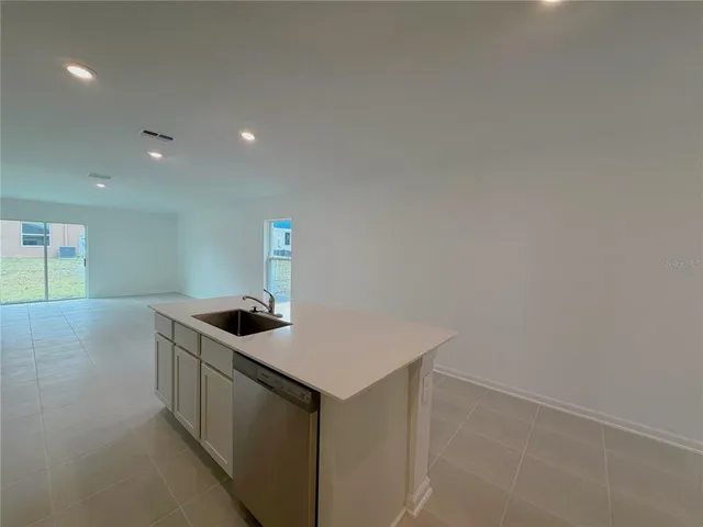 a kitchen that has a sink and a stove