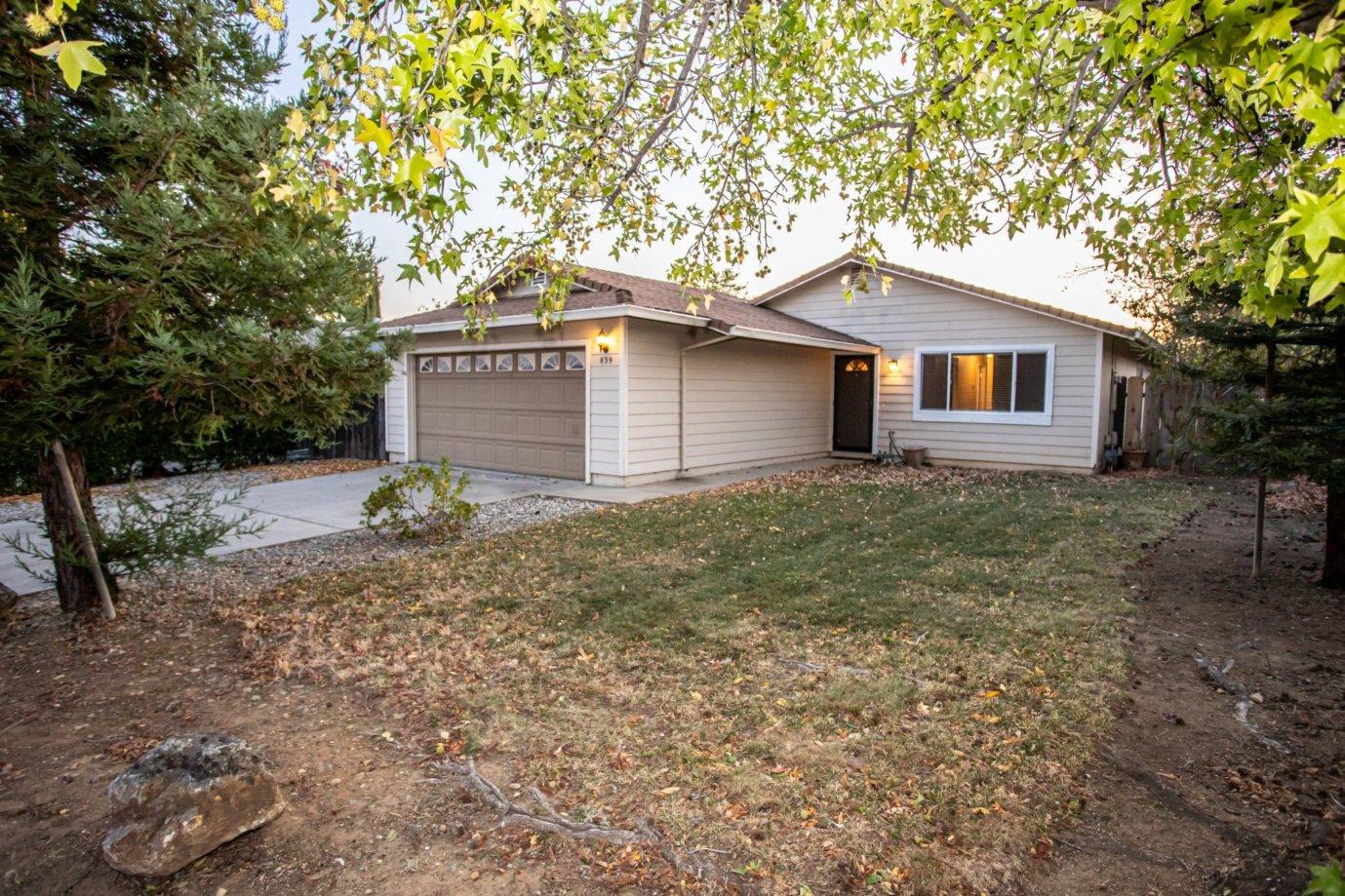 a house that has a tree in front of it
