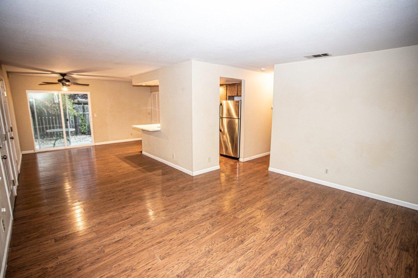 839 Springer Drive Redding, CA 96003 - Photo 2 of 10 a view of an empty room with wooden floor and a window